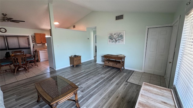 6405 Klaus Ct, Port Charlotte, FL 33981 - living room with wood finished floors, vaulted ceiling, a ceiling fan, and baseboards