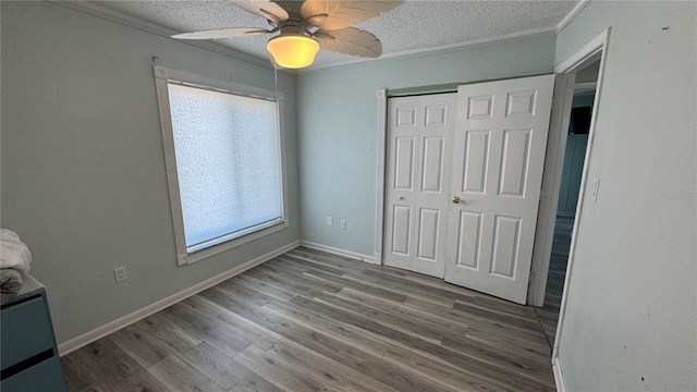 6405 Klaus Ct, Port Charlotte, FL 33981 - unfurnished bedroom featuring a closet, wood finished floors, a textured ceiling, a ceiling fan, and baseboards