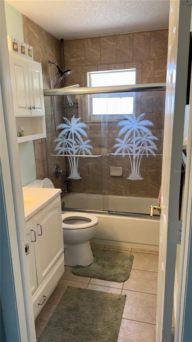 6405 Klaus Ct, Port Charlotte, FL 33981 - full bath featuring toilet, enclosed tub / shower combo, vanity, a textured ceiling, and tile patterned floors