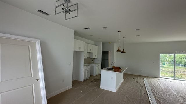 18773 Lake Worth Blvd, Port Charlotte, FL 33948 - kitchen with baseboards, white cabinets, a center island with sink, a sink, and recessed lighting