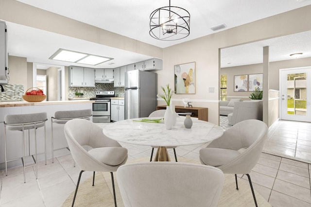 3331 Lime Tree Dr, Edgewater, FL 32141 - dining room with light tile patterned floors and a chandelier