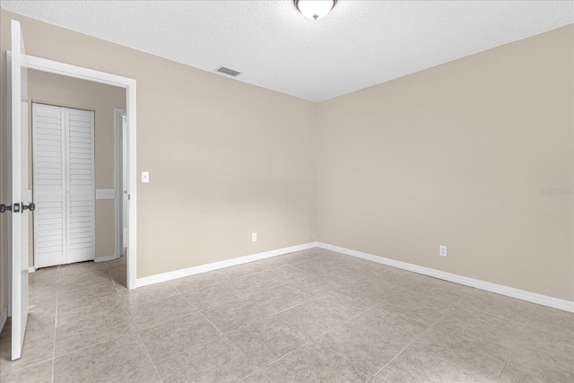 3331 Lime Tree Dr, Edgewater, FL 32141 - spare room featuring light tile patterned flooring, a textured ceiling, and baseboards