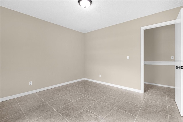3331 Lime Tree Dr, Edgewater, FL 32141 - spare room with tile patterned floors, baseboards, and a textured ceiling