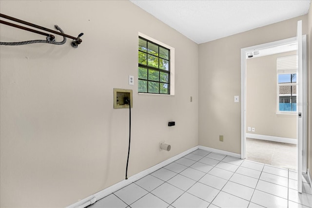 3331 Lime Tree Dr, Edgewater, FL 32141 - laundry room with electric dryer hookup, washer hookup, light tile patterned floors, and baseboards