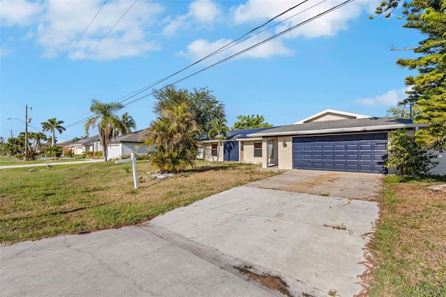 910 SE 23rd Pl, Cape Coral, FL 33990 - ranch-style house with a garage, a front yard, roof mounted solar panels, and concrete driveway
