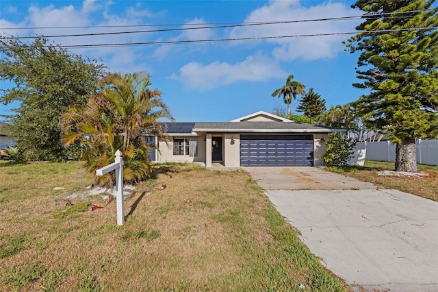 910 SE 23rd Pl, Cape Coral, FL 33990 - ranch-style home with a garage, solar panels, driveway, and stucco siding