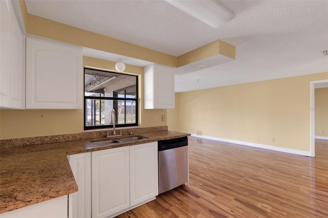 910 SE 23rd Pl, Cape Coral, FL 33990 - kitchen featuring dishwasher, a sink, light wood-style floors, white cabinets, and a textured ceiling