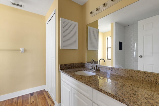910 SE 23rd Pl, Cape Coral, FL 33990 - full bath featuring wood finished floors, vanity, and baseboards