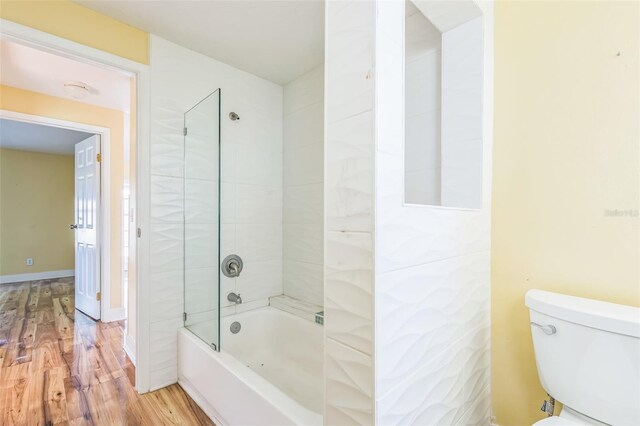 910 SE 23rd Pl, Cape Coral, FL 33990 - bathroom with wood finished floors, bathing tub / shower combination, and toilet