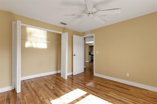 910 SE 23rd Pl, Cape Coral, FL 33990 - unfurnished bedroom with a closet, wood finished floors, baseboards, and a ceiling fan