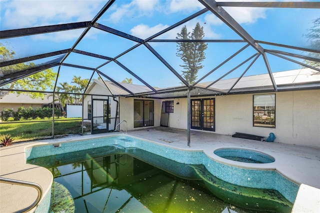 910 SE 23rd Pl, Cape Coral, FL 33990 - outdoor pool with french doors, a patio, a hot tub, and a lanai