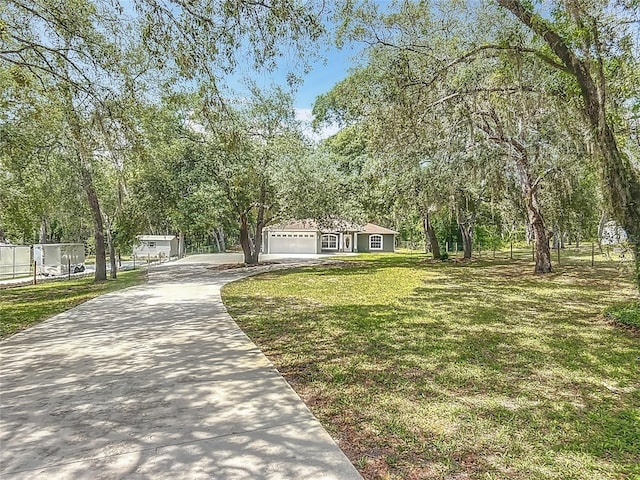 1199 E Mckinley St, Hernando, FL 34442 - view of front facade featuring concrete driveway, a front yard, and a garage
