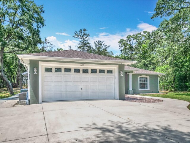 1199 E Mckinley St, Hernando, FL 34442 - single story home with stucco siding, concrete driveway, and an attached garage