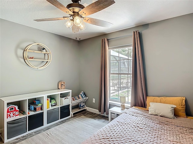 1199 E Mckinley St, Hernando, FL 34442 - bedroom with light wood finished floors, baseboards, a textured ceiling, and a ceiling fan