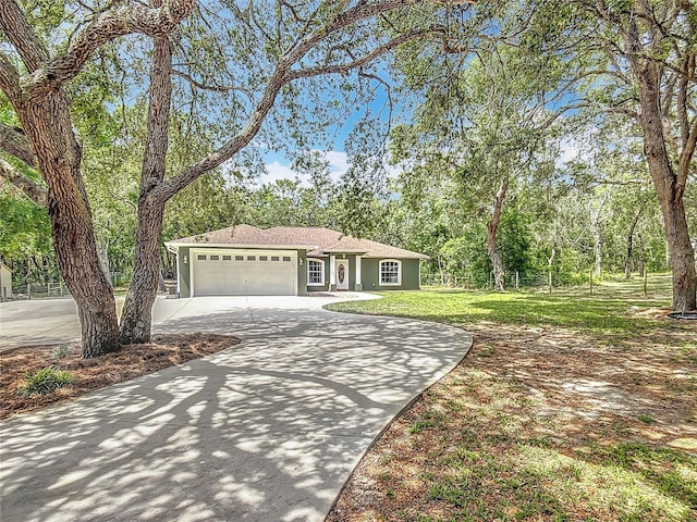 1199 E Mckinley St, Hernando, FL 34442 - single story home featuring curved driveway, a garage, and a front lawn