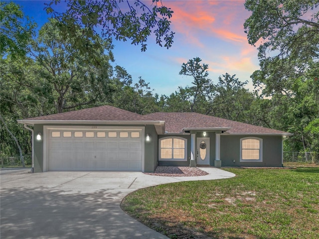1199 E Mckinley St, Hernando, FL 34442 - ranch-style home with stucco siding, a garage, concrete driveway, and roof with shingles