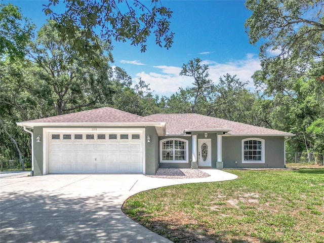 1199 E Mckinley St, Hernando, FL 34442 - ranch-style home featuring stucco siding, a garage, driveway, and a shingled roof