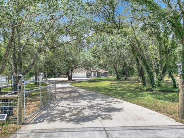 1199 E Mckinley St, Hernando, FL 34442 - view of front of property featuring concrete driveway, a front yard, a garage, and a gate