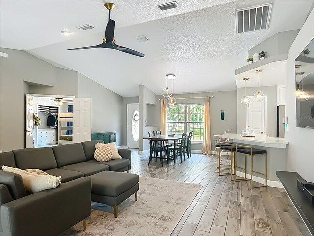 1199 E Mckinley St, Hernando, FL 34442 - living area featuring ceiling fan, light wood finished floors, vaulted ceiling, and baseboards