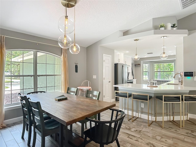 1199 E Mckinley St, Hernando, FL 34442 - dining space featuring a textured ceiling, baseboards, and light wood-style floors