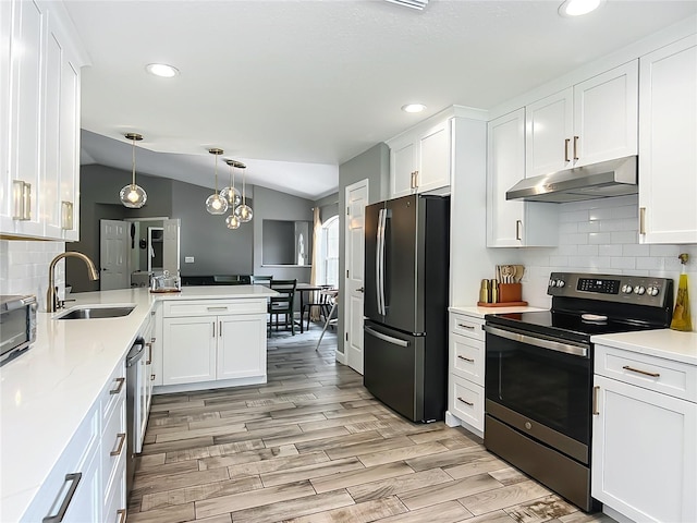 1199 E Mckinley St, Hernando, FL 34442 - kitchen with stainless steel appliances, under cabinet range hood, a sink, a peninsula, and white cabinetry