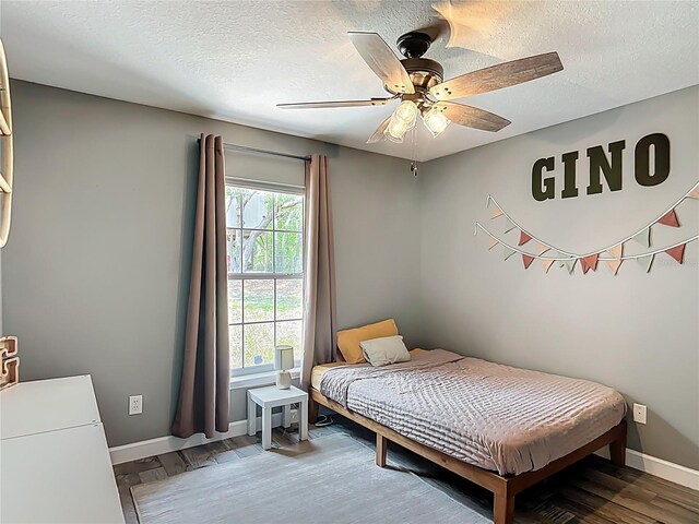 1199 E Mckinley St, Hernando, FL 34442 - bedroom featuring a textured ceiling, baseboards, wood finished floors, and ceiling fan
