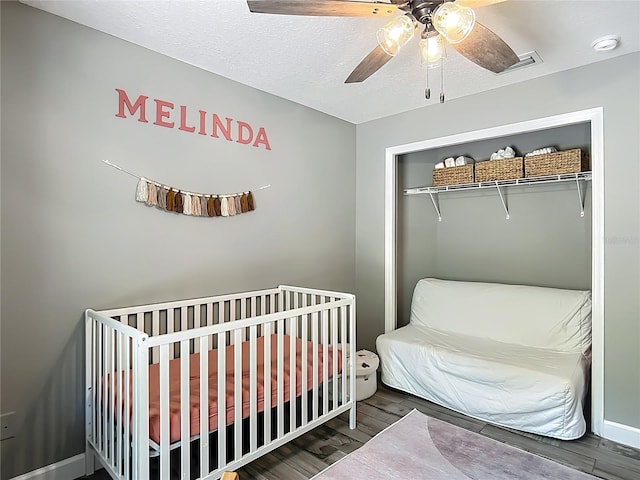 1199 E Mckinley St, Hernando, FL 34442 - bedroom with wood finished floors, a closet, a ceiling fan, and a nursery area