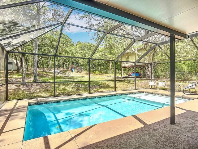 1199 E Mckinley St, Hernando, FL 34442 - swimming pool with a lanai, a patio area, and view of wooded area