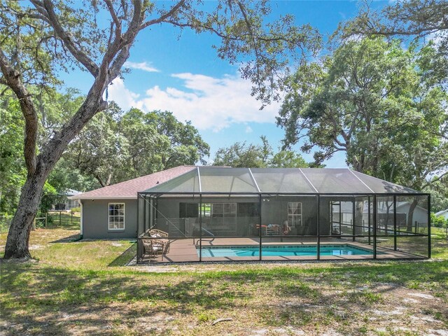 1199 E Mckinley St, Hernando, FL 34442 - back of house with an outdoor pool, a lawn, and a lanai