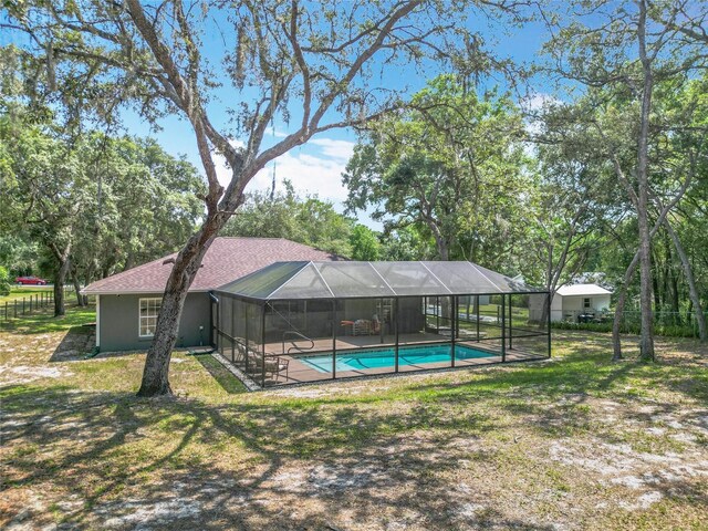 1199 E Mckinley St, Hernando, FL 34442 - swimming pool featuring glass enclosure and a patio area