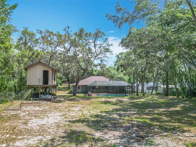 1199 E Mckinley St, Hernando, FL 34442 - view of yard featuring an outdoor pool, a lanai, and view of scattered trees