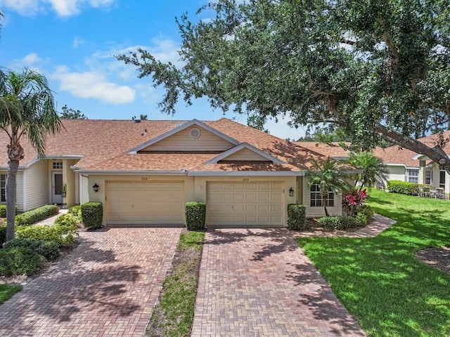 2516 New Haven Cir, Sun City Center, FL 33573 - view of front of property with a shingled roof, a garage, a front lawn, and driveway