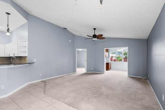 2516 New Haven Cir, Sun City Center, FL 33573 - unfurnished living room featuring vaulted ceiling, ceiling fan, baseboards, and light carpet