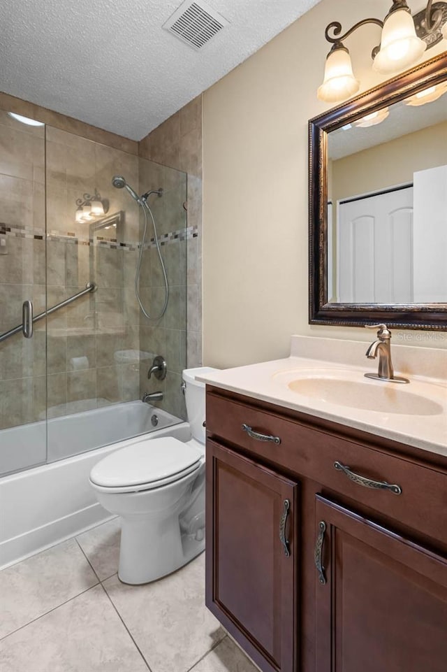 2516 New Haven Cir, Sun City Center, FL 33573 - full bath featuring vanity, bath / shower combo with glass door, toilet, a textured ceiling, and tile patterned flooring
