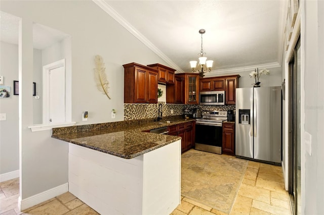 4419 Longshore Dr, Land O Lakes, FL 34639 - kitchen featuring stainless steel appliances, stone tile floors, a peninsula, a chandelier, and crown molding