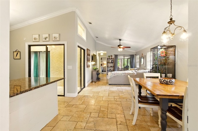 4419 Longshore Dr, Land O Lakes, FL 34639 - dining area featuring stone tile floors, crown molding, lofted ceiling, a ceiling fan, and baseboards