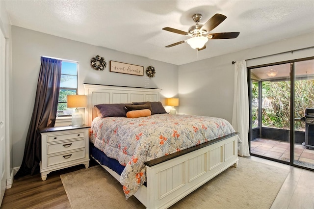 4419 Longshore Dr, Land O Lakes, FL 34639 - bedroom featuring access to outside, multiple windows, wood finished floors, and a ceiling fan