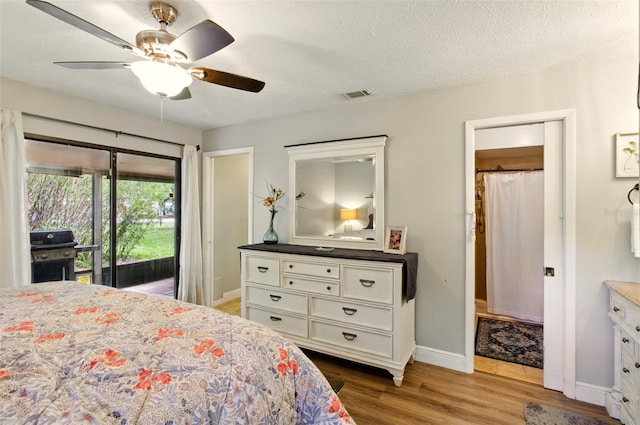 4419 Longshore Dr, Land O Lakes, FL 34639 - bedroom with access to outside, baseboards, wood finished floors, ceiling fan, and a textured ceiling