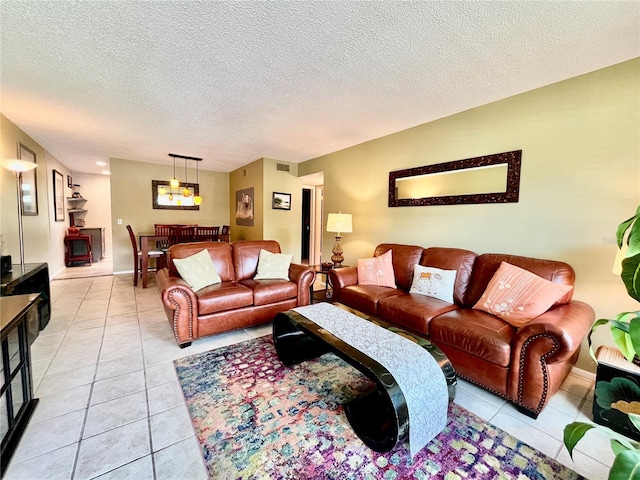 2457 Ecuadorian Way Unit 27, Clearwater, FL 33763 - living room featuring light tile patterned floors, a textured ceiling, and a chandelier