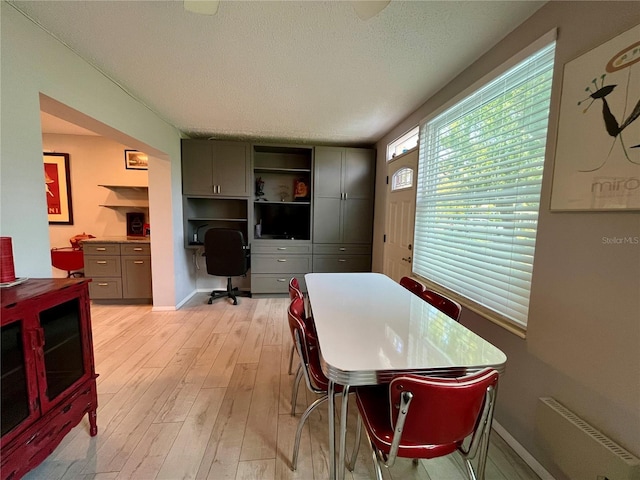 2457 Ecuadorian Way Unit 27, Clearwater, FL 33763 - dining room featuring light wood-style floors, a textured ceiling, an office area, and baseboards