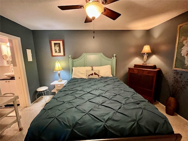 2457 Ecuadorian Way Unit 27, Clearwater, FL 33763 - bedroom with carpet, ceiling fan, a textured ceiling, and connected bathroom