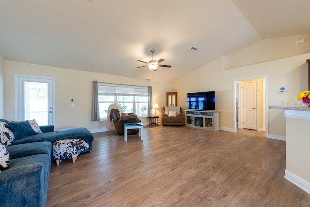 3642 Fantasy Way, Brooksville, FL 34604 - living room with a ceiling fan, vaulted ceiling, light wood-style floors, plenty of natural light, and baseboards