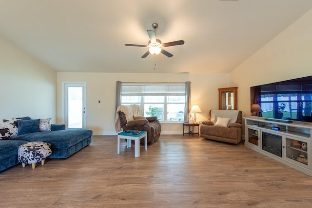 3642 Fantasy Way, Brooksville, FL 34604 - living room featuring lofted ceiling, wood finished floors, plenty of natural light, a ceiling fan, and baseboards