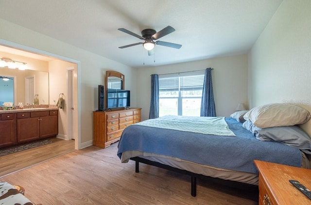 3642 Fantasy Way, Brooksville, FL 34604 - bedroom featuring light wood-type flooring, ensuite bathroom, a ceiling fan, and baseboards