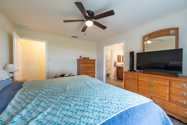 3642 Fantasy Way, Brooksville, FL 34604 - bedroom with ceiling fan, wood finished floors, and ensuite bathroom
