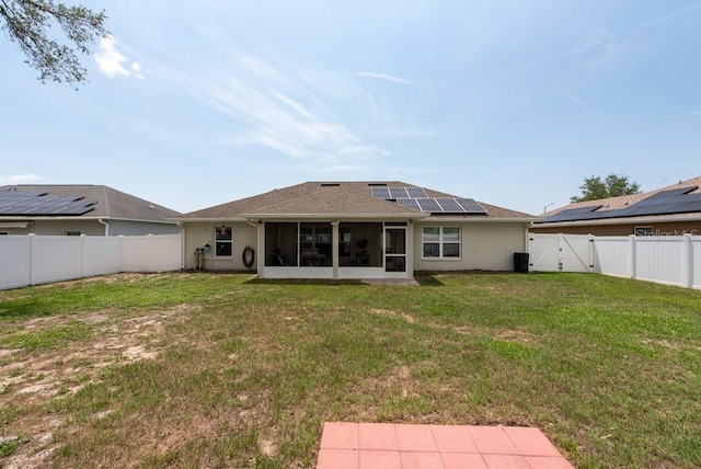 3642 Fantasy Way, Brooksville, FL 34604 - back of house with a sunroom, a gate, roof mounted solar panels, and stucco siding