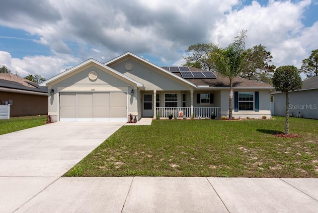 3642 Fantasy Way, Brooksville, FL 34604 - ranch-style home with a porch, a garage, roof mounted solar panels, a front lawn, and concrete driveway