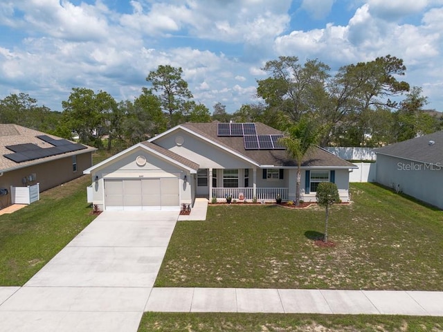 3642 Fantasy Way, Brooksville, FL 34604 - view of front of house with a porch, an attached garage, solar panels, a front lawn, and concrete driveway