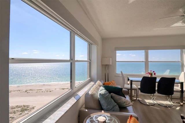 1270 Gulf Blvd Unit 1901, Clearwater Beach, FL 33767 - sunroom / solarium featuring wood finished floors, a water view, and a textured ceiling