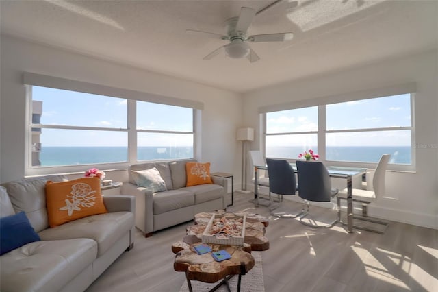 1270 Gulf Blvd Unit 1901, Clearwater Beach, FL 33767 - living room featuring plenty of natural light, light wood-style flooring, a ceiling fan, and a water view